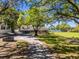 Spacious property with a well-maintained lawn, mature trees, and a long driveway at 498 Lakewood Dr, Brandon, FL 33510