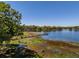 Scenic lake view with a private wooden dock extending into the water at 498 Lakewood Dr, Brandon, FL 33510