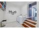 Bright laundry room with white washer and dryer, tile floors, and wire shelving at 498 Lakewood Dr, Brandon, FL 33510