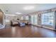 Open concept living room featuring hardwood floors and comfortable seating with lots of natural light at 498 Lakewood Dr, Brandon, FL 33510