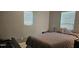 Bedroom with neutral colors, featuring a bed and two windows offering plenty of natural light at 522 Mclennan St, Clearwater, FL 33756