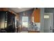 Well-lit kitchen with black appliances, granite countertops, and views of the backyard at 522 Mclennan St, Clearwater, FL 33756