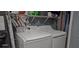 Bright laundry room with modern washer and dryer, and overhead shelving at 522 Mclennan St, Clearwater, FL 33756