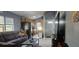 The open living space offers wood-look tile flooring, a view of the kitchen, and a bright front door at 522 Mclennan St, Clearwater, FL 33756