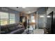 Cozy living room with ample natural light, leading into the kitchen with modern, stainless steel appliances at 522 Mclennan St, Clearwater, FL 33756