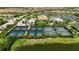 Aerial view of tennis and pickleball courts, surrounded by lush landscaping in the community at 5420 Cicerone St # 103, Sarasota, FL 34238