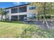 Exterior view of a screened-in patio and backyard, showcasing a tranquil outdoor living space at 5420 Cicerone St # 103, Sarasota, FL 34238