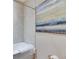 Bright bathroom featuring tiled shower-tub combo and modern abstract art at 5420 Cicerone St # 103, Sarasota, FL 34238