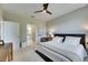 Spacious bedroom with a ceiling fan, carpet floors, and an ensuite bathroom and closet at 5420 Cicerone St # 103, Sarasota, FL 34238