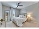 Comfortable bedroom with a ceiling fan, white curtains, and natural light at 5420 Cicerone St # 103, Sarasota, FL 34238