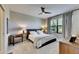 Bright and airy main bedroom featuring a ceiling fan, a large window and neutral-toned walls at 5420 Cicerone St # 103, Sarasota, FL 34238