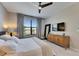 Bedroom featuring carpet floors, large TV, and a large window with beautiful landscape views at 5420 Cicerone St # 103, Sarasota, FL 34238