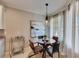 Well-lit breakfast nook with a modern table, chairs, and a view of natural light and decor at 5420 Cicerone St # 103, Sarasota, FL 34238