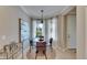 Bright breakfast nook with modern lighting and a view of the outdoors through sheer curtains at 5420 Cicerone St # 103, Sarasota, FL 34238