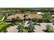 Aerial view of the community clubhouse with lush landscaping, and ample parking perfect for gatherings and events at 5420 Cicerone St # 103, Sarasota, FL 34238