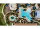 Overhead aerial view of a community pool and playground featuring several pools, cabanas, and landscaping at 5420 Cicerone St # 103, Sarasota, FL 34238