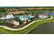 Aerial view of the resort-style pool with sun loungers, umbrellas, and lush landscaping, perfect for relaxation and recreation at 5420 Cicerone St # 103, Sarasota, FL 34238