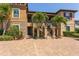 Charming two-story condo featuring a stone facade, lush landscaping, and a private entrance with well-maintained stairs at 5420 Cicerone St # 103, Sarasota, FL 34238
