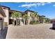 Elegant condo complex showcases beautiful architecture, lush landscaping, and private entrances under a bright sky at 5420 Cicerone St # 103, Sarasota, FL 34238