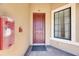 The residence's front door is framed by a window and a red emergency fire extinguisher at 5420 Cicerone St # 103, Sarasota, FL 34238