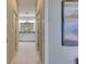 Bright hallway with tile floors and painting on wall, leading to an ensuite bathroom at 5420 Cicerone St # 103, Sarasota, FL 34238