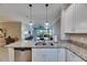 Bright kitchen featuring granite countertops, stainless steel appliances, and pendant lighting at 5420 Cicerone St # 103, Sarasota, FL 34238