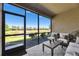 Enclosed lanai featuring comfortable seating and a peaceful view of the lake at 5420 Cicerone St # 103, Sarasota, FL 34238