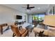 Bright living room featuring modern furnishings, a ceiling fan, and sliding glass doors to the outside at 5420 Cicerone St # 103, Sarasota, FL 34238