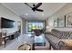 Comfortable living room with neutral tones and balcony access, perfect for relaxing at 5420 Cicerone St # 103, Sarasota, FL 34238