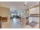 Open-concept living space with modern kitchen island, dining area, and balcony access at 5420 Cicerone St # 103, Sarasota, FL 34238
