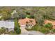 A high angle shot captures the home with its orange tile roof surrounded by lush trees at 5473 Blue Heron Ln, Wesley Chapel, FL 33543