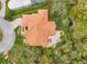 Aerial view of neighborhood with orange tile roof homes surrounded by lush greenery at 5473 Blue Heron Ln, Wesley Chapel, FL 33543
