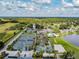 Wide aerial shot of tennis courts and a community pool area, surrounded by lush greenery and recreational facilities at 5473 Blue Heron Ln, Wesley Chapel, FL 33543
