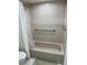 This cozy bathroom has a shower-tub combo and modern grab bar at 5473 Blue Heron Ln, Wesley Chapel, FL 33543