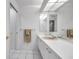 The bathroom features a pink sink, white cabinets, and plenty of natural light at 5473 Blue Heron Ln, Wesley Chapel, FL 33543