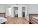 Bright bedroom with hardwood flooring, two closets, and a sitting area at 5473 Blue Heron Ln, Wesley Chapel, FL 33543