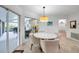 Bright dining area with tile flooring, modern light fixture, and access to the patio at 5473 Blue Heron Ln, Wesley Chapel, FL 33543