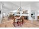 Elegant dining area with mirror, wood furniture, and flooring creates a sophisticated and open ambiance at 5473 Blue Heron Ln, Wesley Chapel, FL 33543