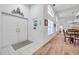 The foyer features wood floors, white walls, and natural light flowing into this bright home at 5473 Blue Heron Ln, Wesley Chapel, FL 33543