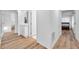 Bright hallway with wood floors, white walls, and views of other rooms in the home at 5473 Blue Heron Ln, Wesley Chapel, FL 33543