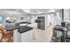 The kitchen features granite countertops, stainless steel appliances, and bar stool seating at 5473 Blue Heron Ln, Wesley Chapel, FL 33543