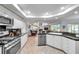 A spacious kitchen features granite countertops and opens to a living room with natural light at 5473 Blue Heron Ln, Wesley Chapel, FL 33543