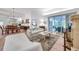 Inviting living room features neutral furnishings, a fireplace, and sliding glass doors to a screened porch at 5473 Blue Heron Ln, Wesley Chapel, FL 33543