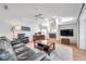 The living room features a fireplace, a large leather couch, and natural lighting at 5473 Blue Heron Ln, Wesley Chapel, FL 33543