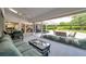 Large enclosed patio with outdoor seating and access to the landscaped backyard at 5473 Blue Heron Ln, Wesley Chapel, FL 33543