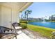 Relaxing balcony view with wicker chairs overlooking a tranquil lake with palm trees in a desirable community at 6061 Bahia Del Mar Blvd # 112, St Petersburg, FL 33715