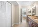 Bathroom with vanity, tile floor, and closet; bedroom can be seen through the doorway at 6061 Bahia Del Mar Blvd # 112, St Petersburg, FL 33715