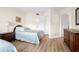 Comfortable bedroom with twin bed, wood look floors, dresser, and closet in neutral color palette at 6061 Bahia Del Mar Blvd # 112, St Petersburg, FL 33715