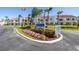 Community entrance with manicured landscaping, signage, and buildings in the background at 6061 Bahia Del Mar Blvd # 112, St Petersburg, FL 33715