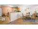 Bright dining area shows glass table, wicker chairs, and bar to kitchen at 6061 Bahia Del Mar Blvd # 112, St Petersburg, FL 33715